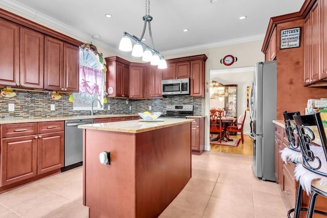 kitchen featuring a kitchen island, appliances with stainless steel finishes, pendant lighting, backsplash, and crown molding