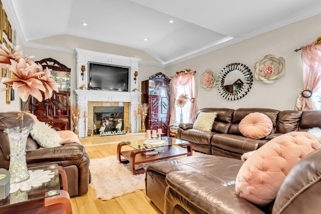 living room with ornamental molding, vaulted ceiling, and light hardwood / wood-style floors