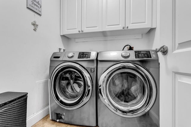 washroom featuring independent washer and dryer and cabinets