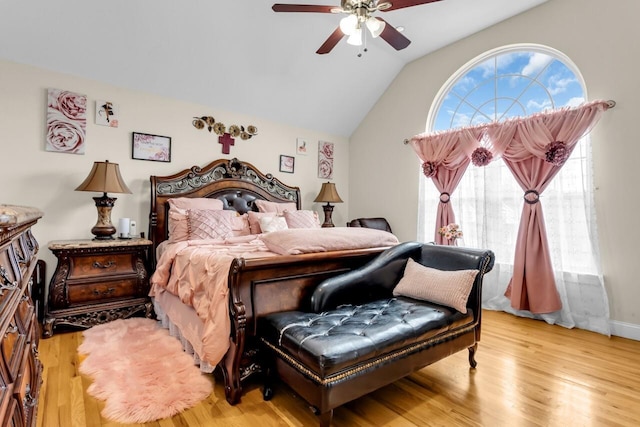 bedroom with lofted ceiling, light hardwood / wood-style flooring, and ceiling fan