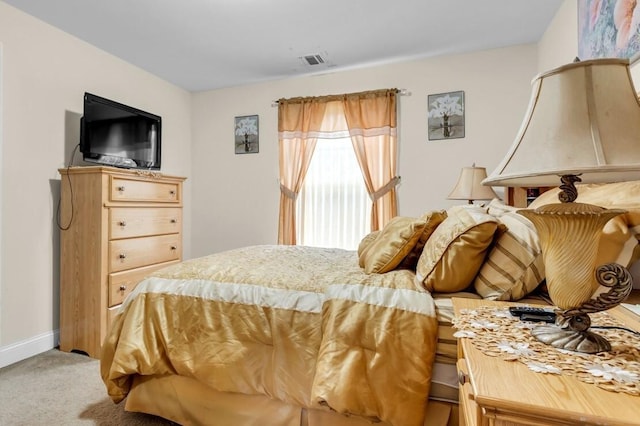 bedroom featuring light carpet