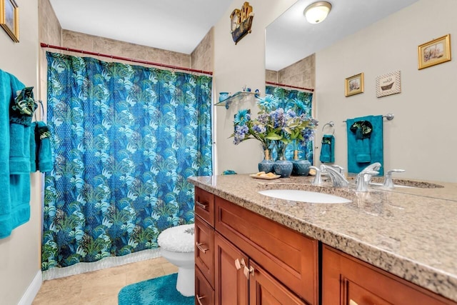 bathroom with vanity, tile patterned floors, and toilet