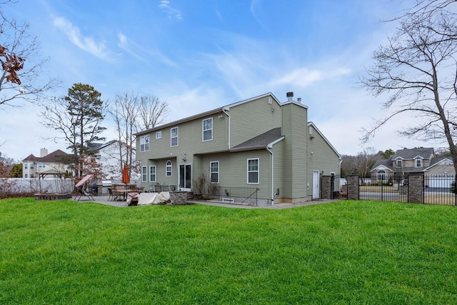 back of property featuring a yard and a patio