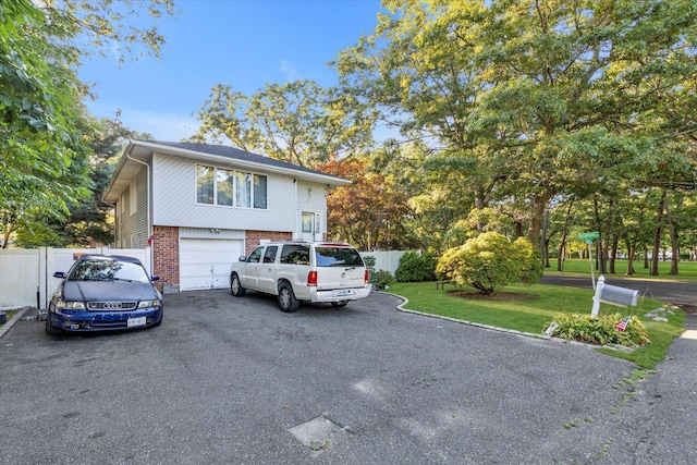 view of front of property featuring a garage and a front lawn