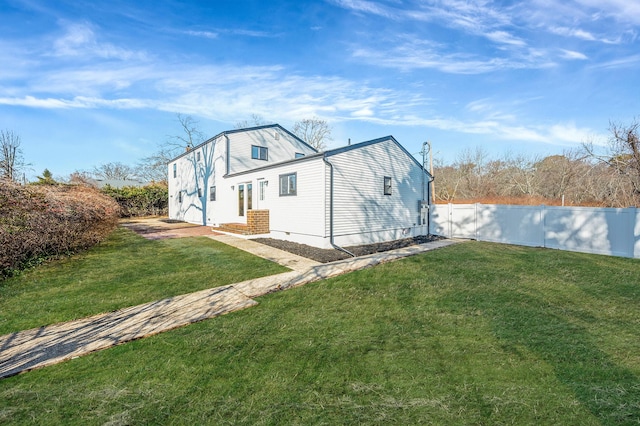 view of side of property with a yard