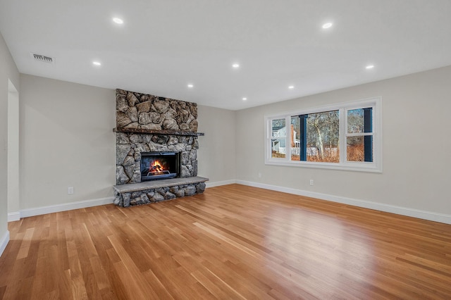 unfurnished living room featuring a fireplace and light wood-type flooring