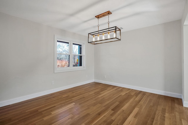 unfurnished room with hardwood / wood-style floors