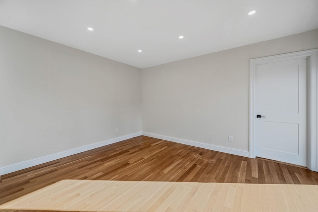 unfurnished room featuring hardwood / wood-style flooring