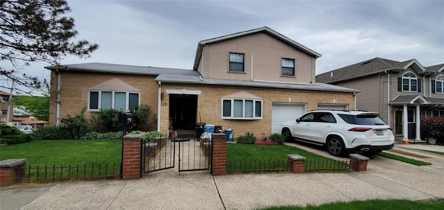 view of front of property featuring a garage and a front lawn