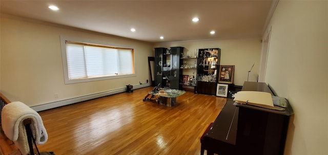 miscellaneous room with ornamental molding, hardwood / wood-style floors, and a baseboard heating unit