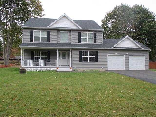 view of front of property with a garage, a front yard, and a porch