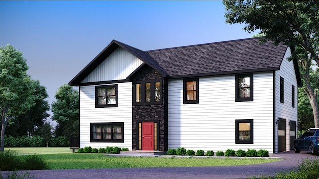 view of front of home with a garage and a front yard