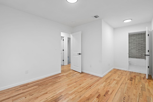 empty room with light hardwood / wood-style flooring