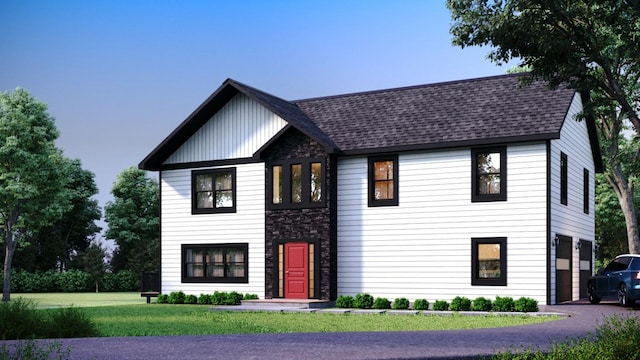 view of front facade featuring a garage and a front lawn