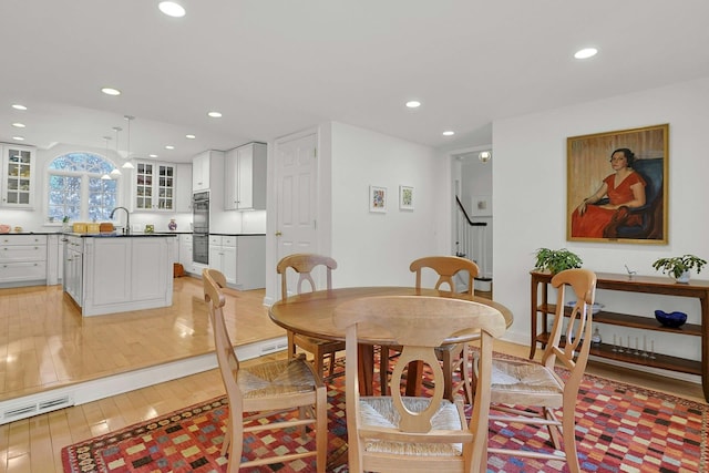 dining area with light wood-type flooring, stairs, visible vents, and recessed lighting