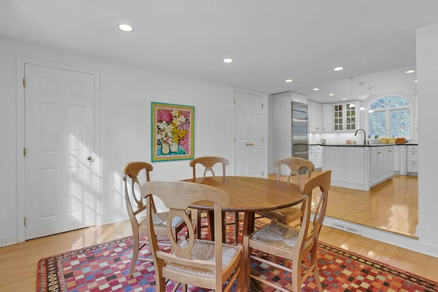 dining room featuring light wood-style flooring and recessed lighting