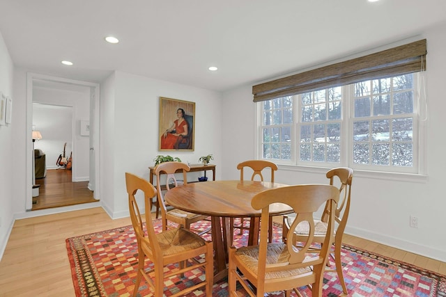 dining area with baseboards, recessed lighting, and light wood-style floors