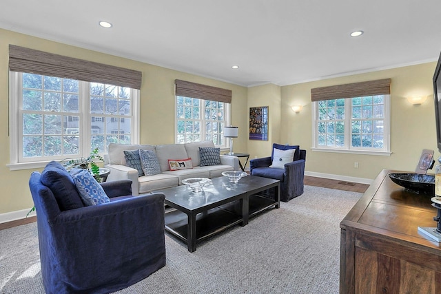 living area with recessed lighting, a wealth of natural light, and baseboards