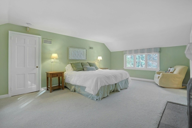 bedroom with lofted ceiling, visible vents, and carpet flooring