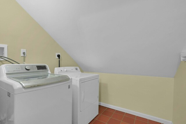 washroom featuring baseboards, laundry area, dark tile patterned floors, and washer and dryer