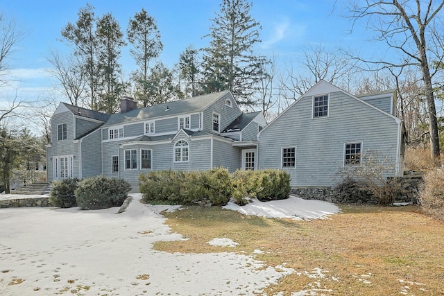 rear view of house featuring a chimney