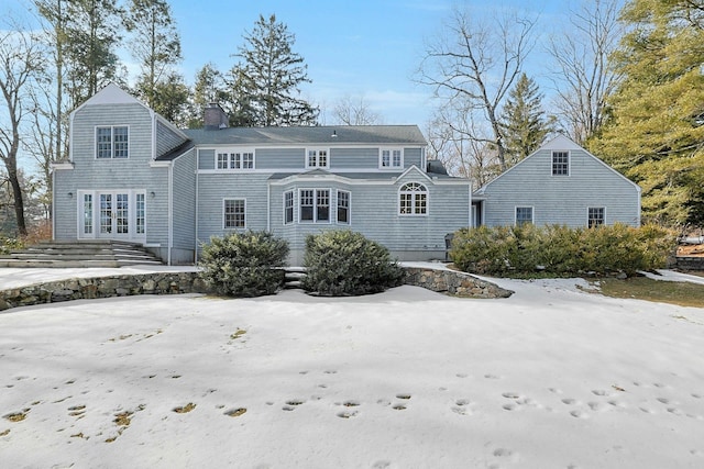 view of front of house featuring a chimney and french doors