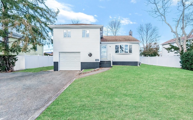 view of front of house with a garage and a front yard