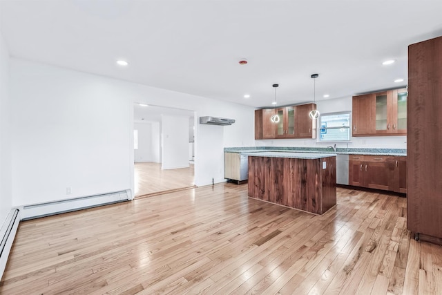 kitchen featuring a baseboard heating unit, decorative light fixtures, light hardwood / wood-style flooring, and a center island