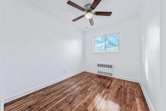 spare room with ceiling fan, ornamental molding, radiator heating unit, and hardwood / wood-style floors