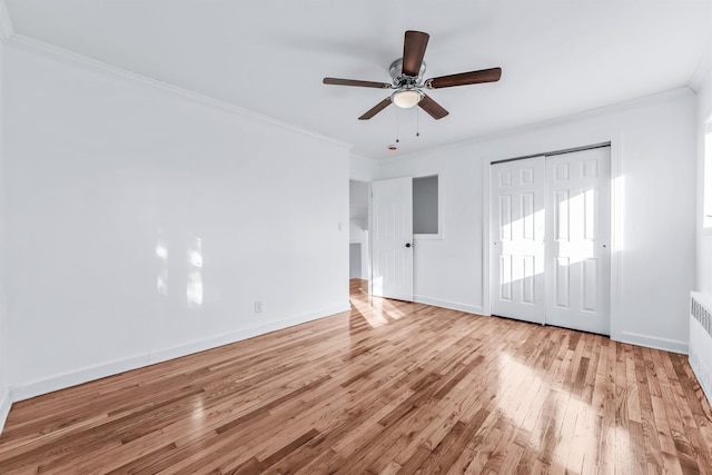 unfurnished bedroom featuring ornamental molding, a closet, ceiling fan, and light wood-type flooring