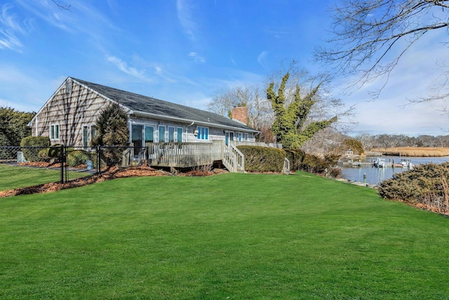 exterior space featuring a deck with water view