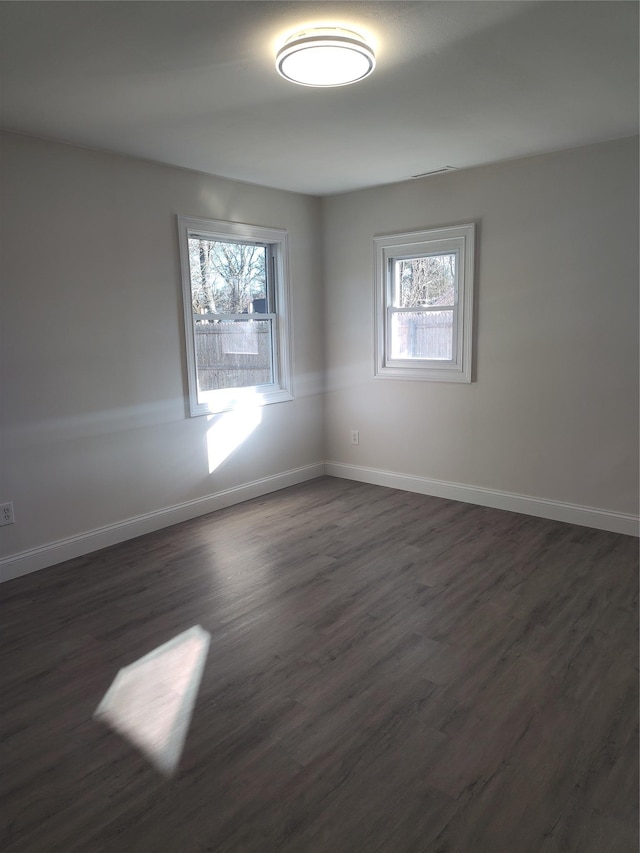 spare room featuring dark wood-type flooring