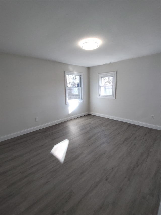 spare room featuring dark wood-type flooring