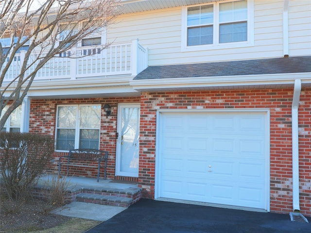 doorway to property with a balcony and a garage