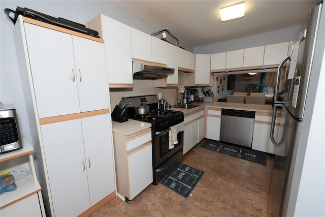 kitchen featuring stainless steel appliances, sink, and white cabinets