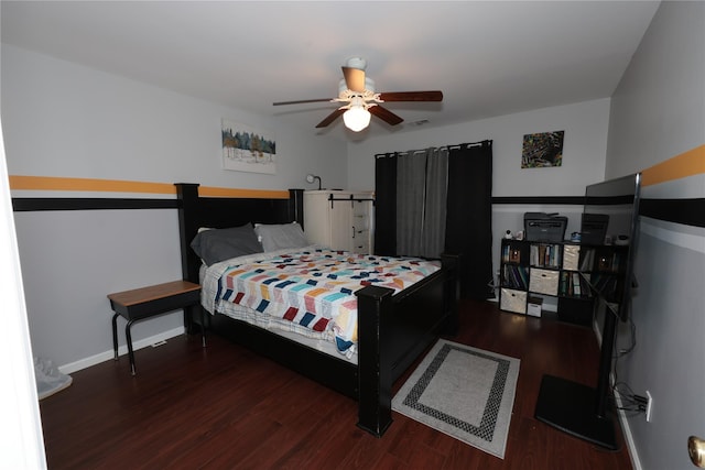 bedroom with dark hardwood / wood-style floors and ceiling fan