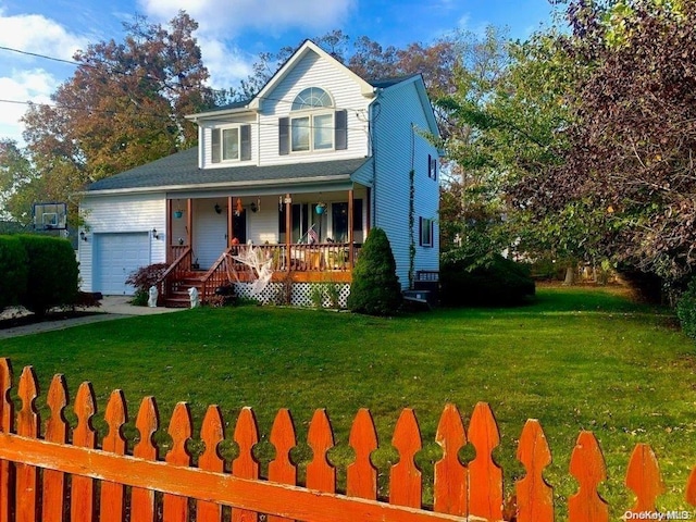 view of front of home featuring a garage, a front yard, and covered porch