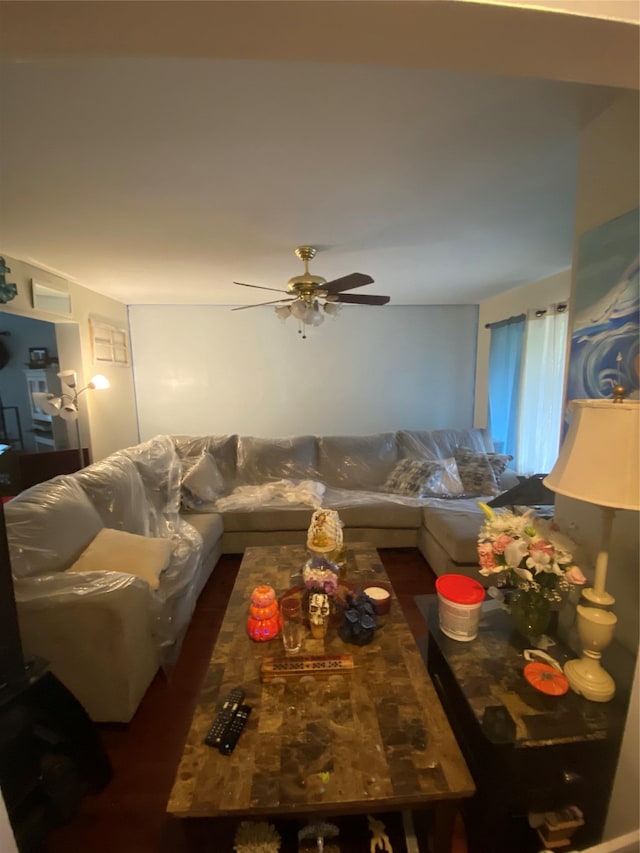 living room featuring dark hardwood / wood-style flooring and ceiling fan