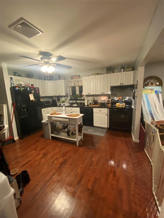 kitchen with dark hardwood / wood-style floors, white cabinetry, backsplash, ceiling fan, and black appliances