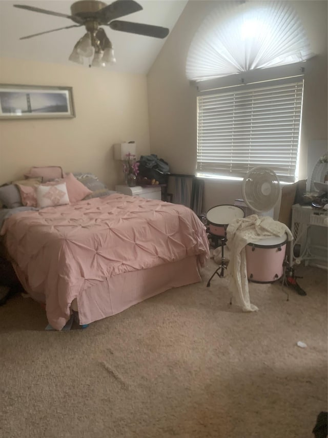 bedroom with lofted ceiling, ceiling fan, and carpet