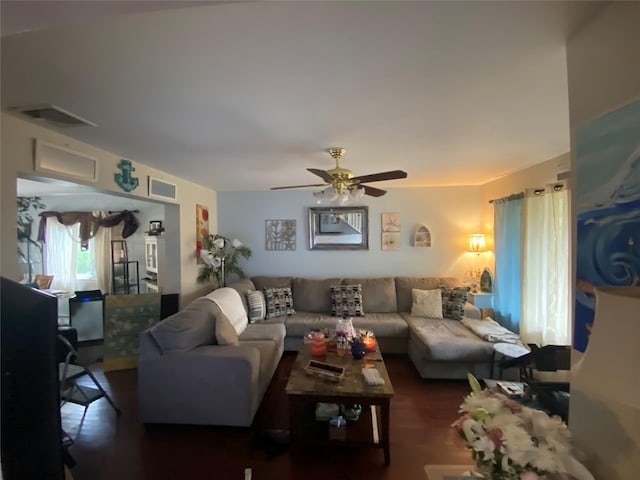 living room with dark hardwood / wood-style flooring and ceiling fan