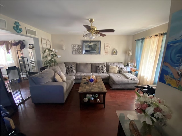 living room featuring a wealth of natural light and ceiling fan