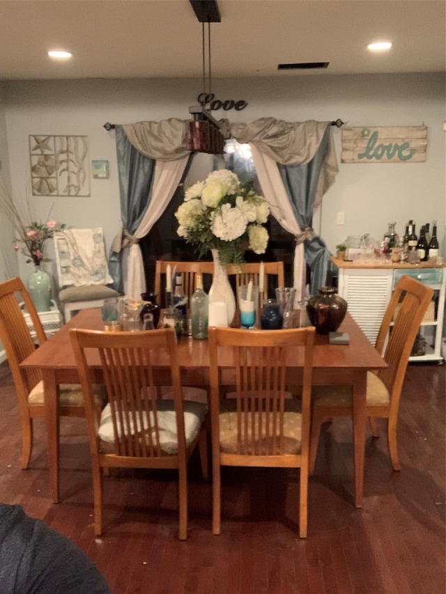 dining space with dark hardwood / wood-style flooring