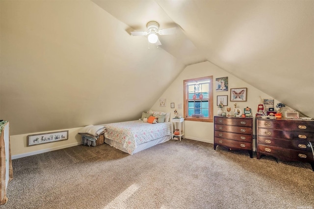 unfurnished bedroom featuring ceiling fan, vaulted ceiling, and carpet