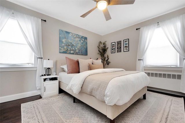 bedroom featuring radiator, wood-type flooring, and ceiling fan