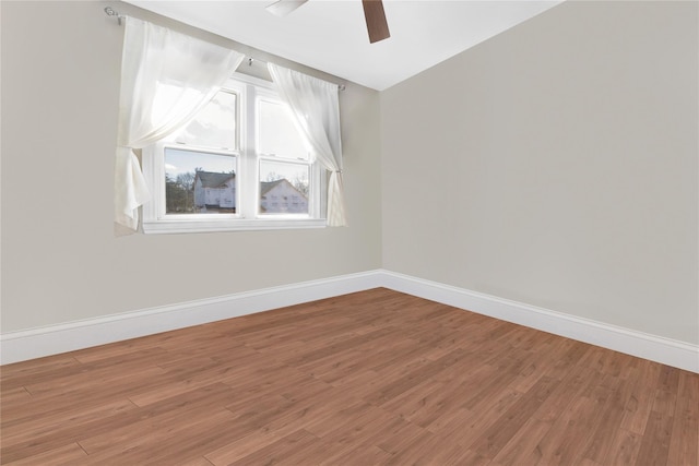 spare room featuring vaulted ceiling, hardwood / wood-style floors, and ceiling fan