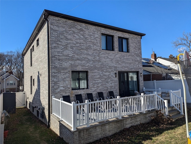 back of property featuring a deck