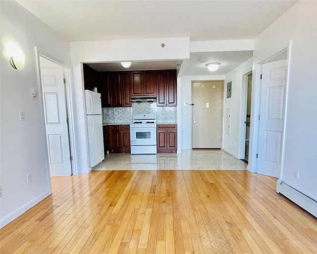 kitchen with white appliances, a baseboard radiator, light hardwood / wood-style floors, and backsplash