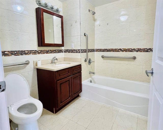 full bathroom featuring tiled shower / bath combo, vanity, tile walls, and toilet