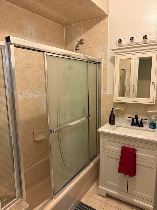 bathroom featuring vanity, tile patterned floors, and shower / bath combination with glass door